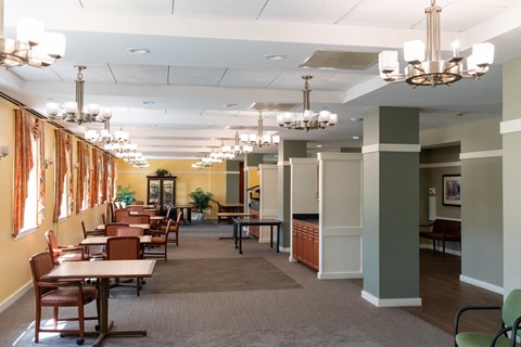 a large dining room with tables and chairs and chandeliers