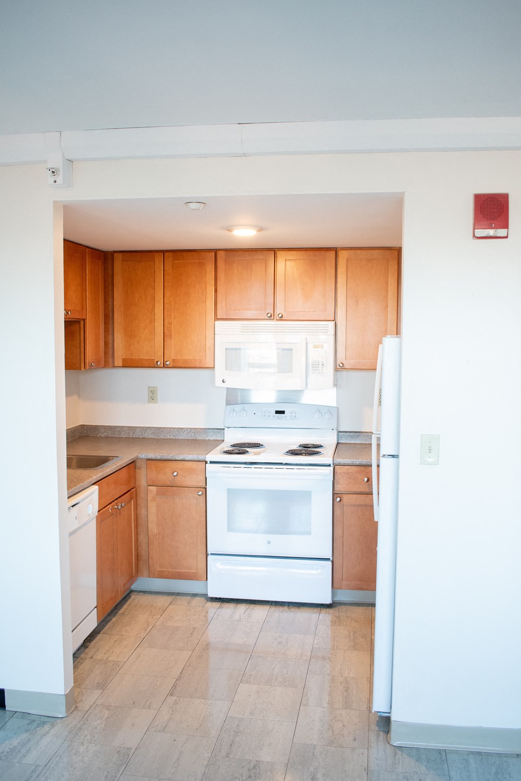 A kitchen with wooden cabinets and white appliances.