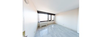 A room with a window and a radiator on the wall.