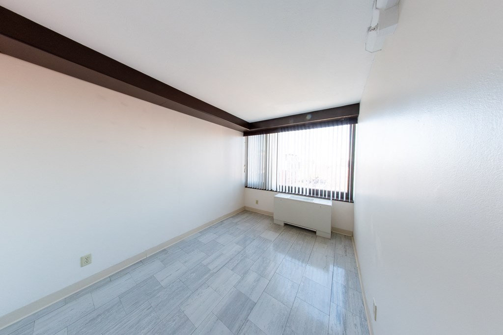 A room with a window and a radiator.