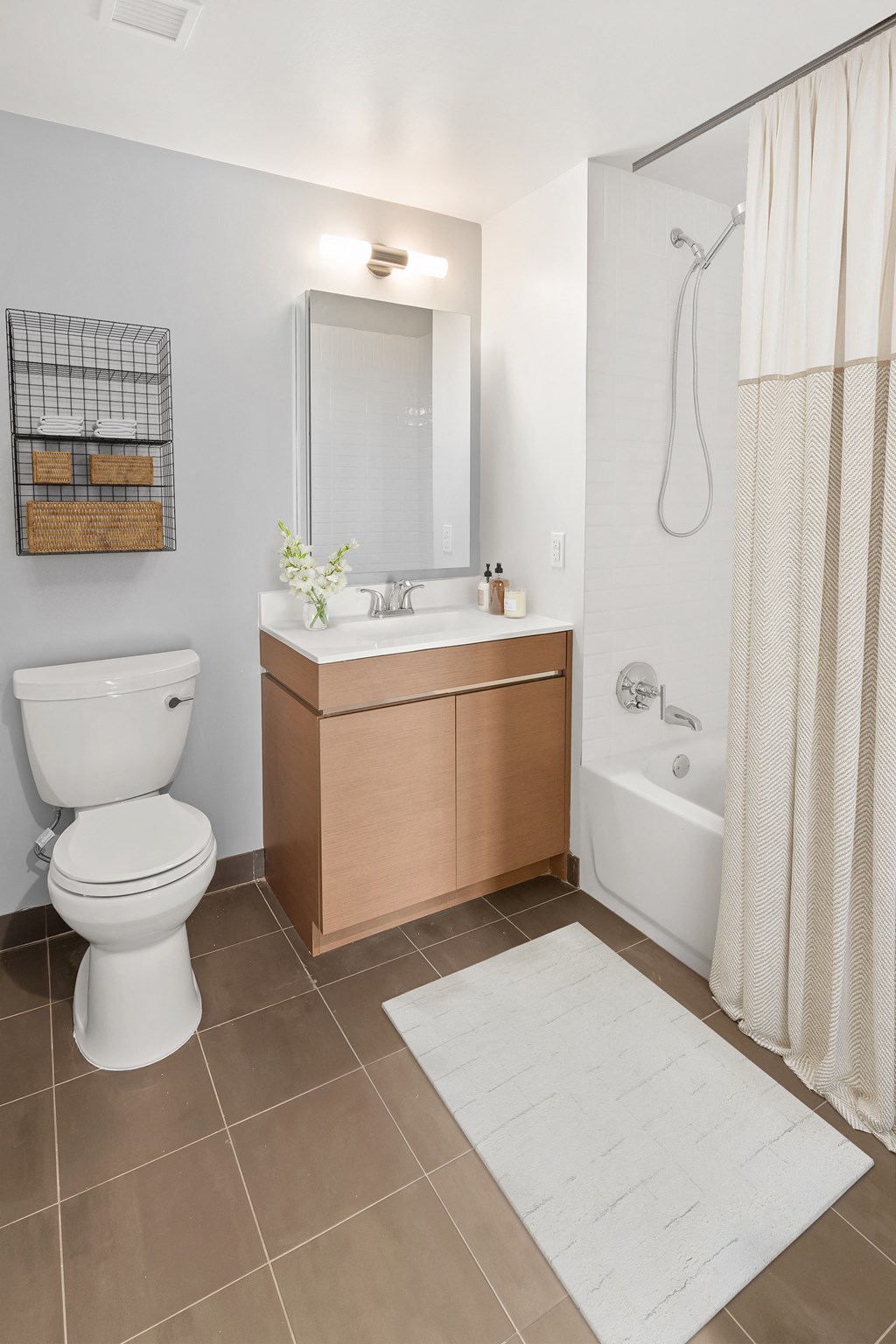 a bathroom with a toilet and a sink and a shower