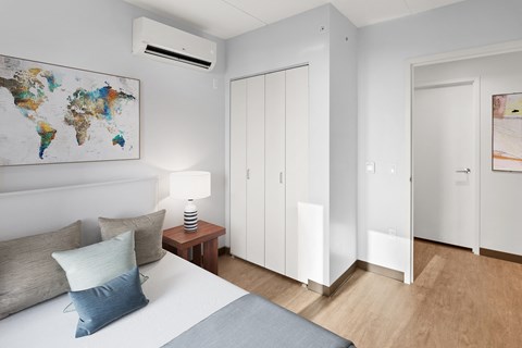 a bedroom with a bed and a world map on the wall