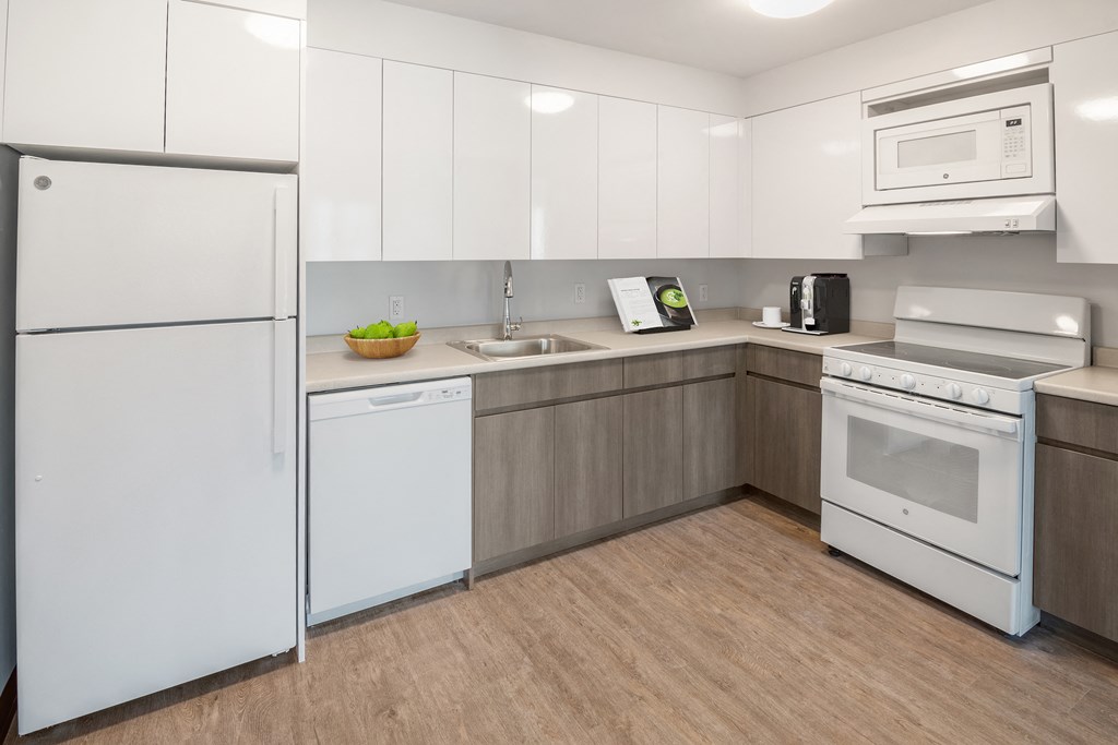 a kitchen with white appliances and white cabinets