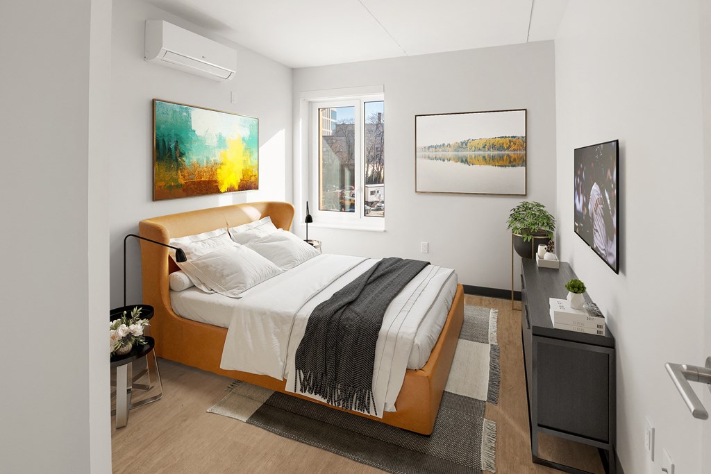 a bedroom with a bed and a window