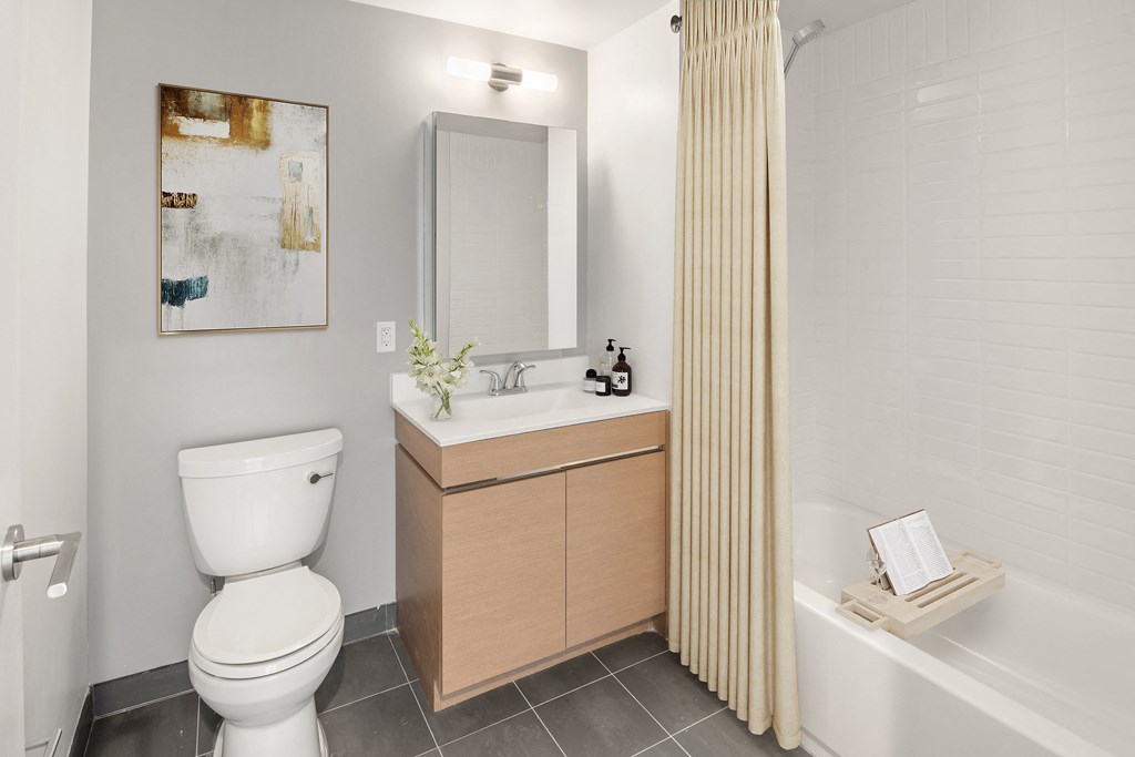 a bathroom with a toilet sink and tub and a shower