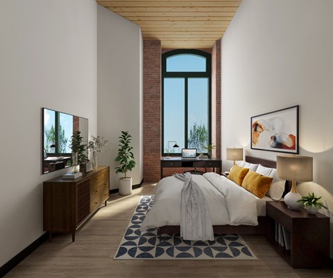 a bedroom with a large bed and a large window
