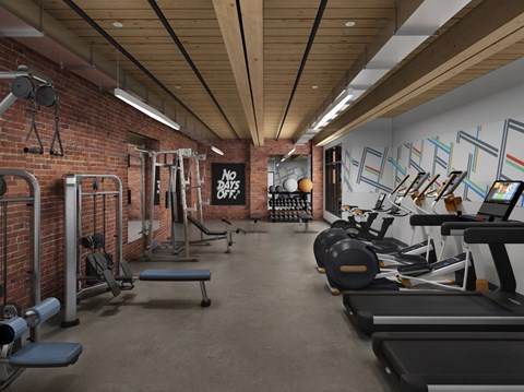 a gym with a brick wall and wood ceiling