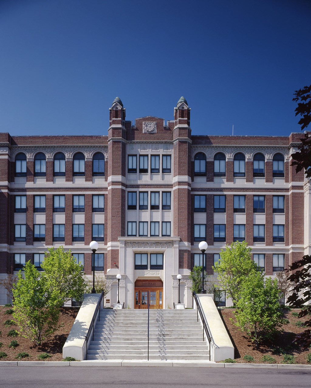 a large brick building with stairs in front of it