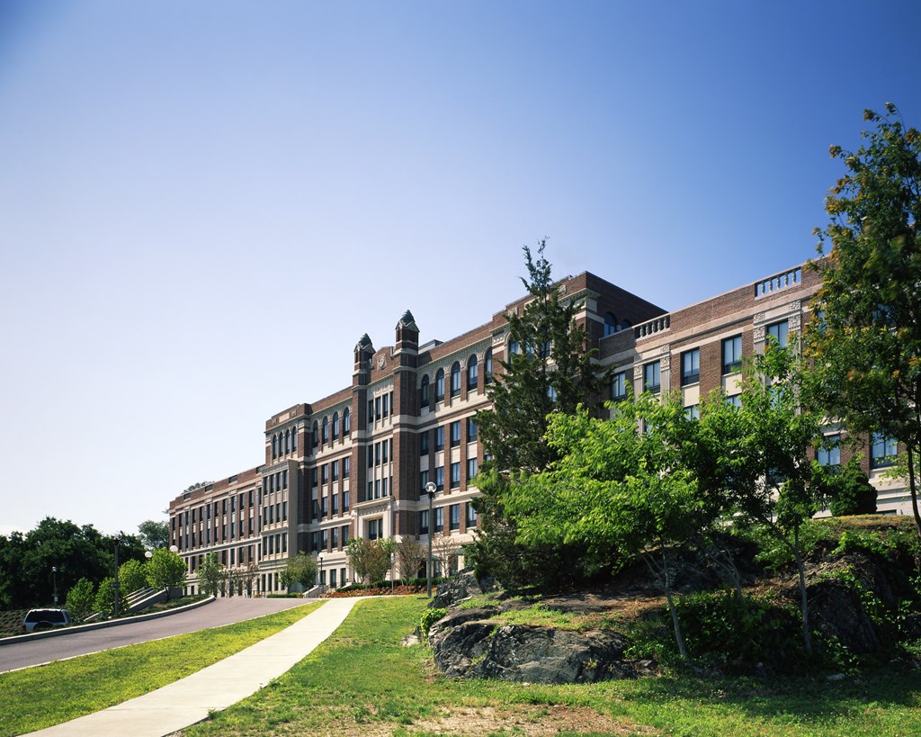 a large brick building with trees in front of it