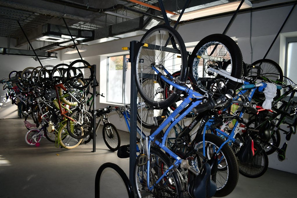 a rack full of bikes in a building with other bikes on it
