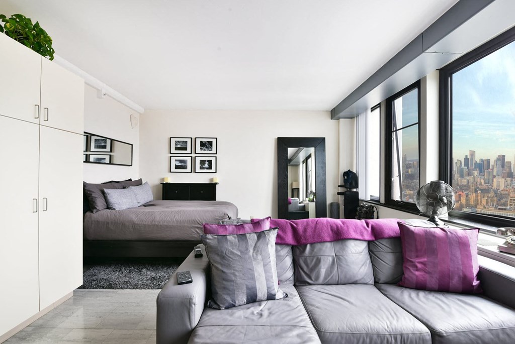 a living room with a couch and a bed