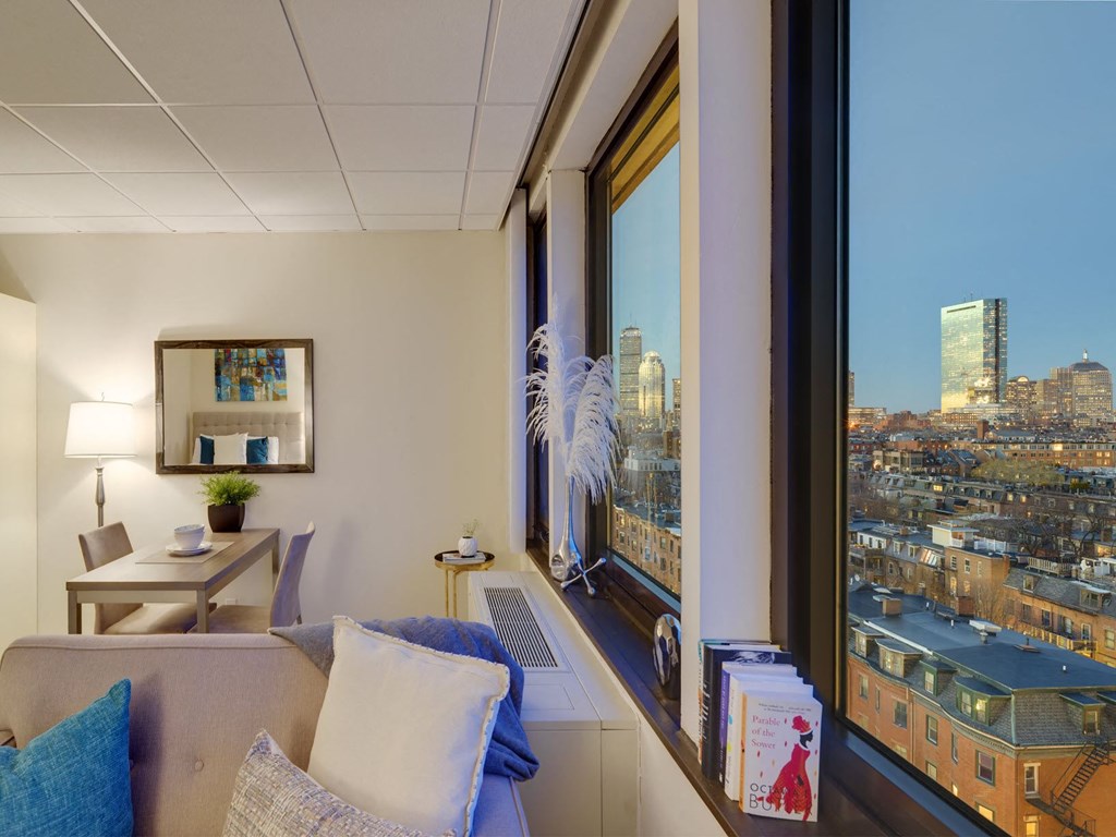 a living room with a couch and a view of the city