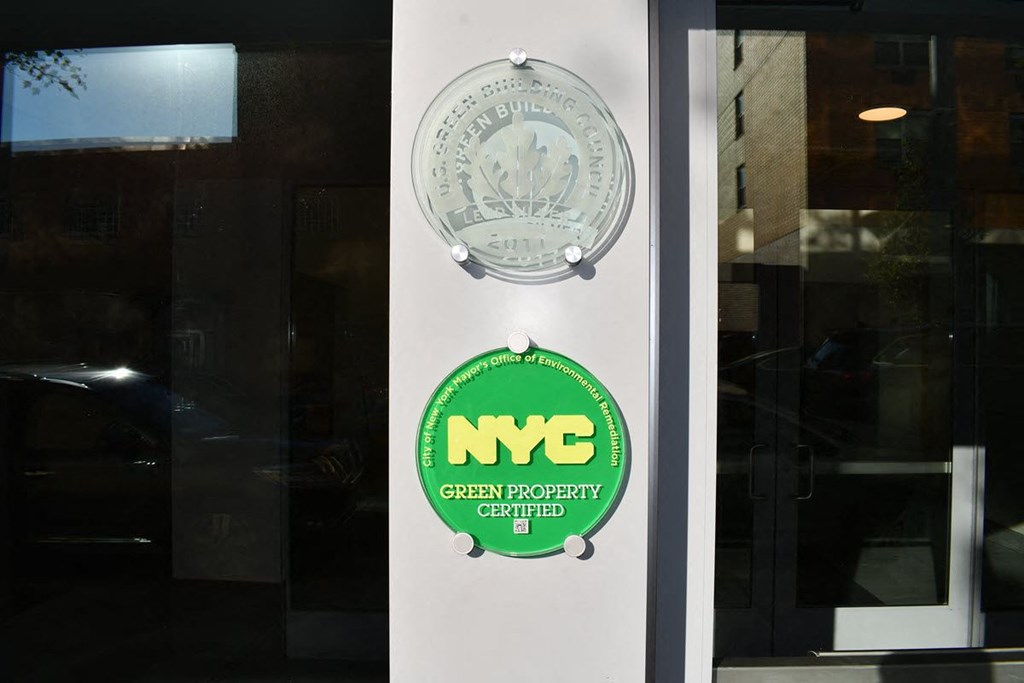the logo of the nyc green footprint corporation on the door of a building
