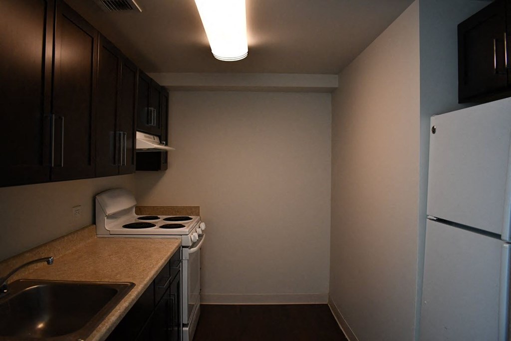 a small kitchen with a stove and a refrigerator