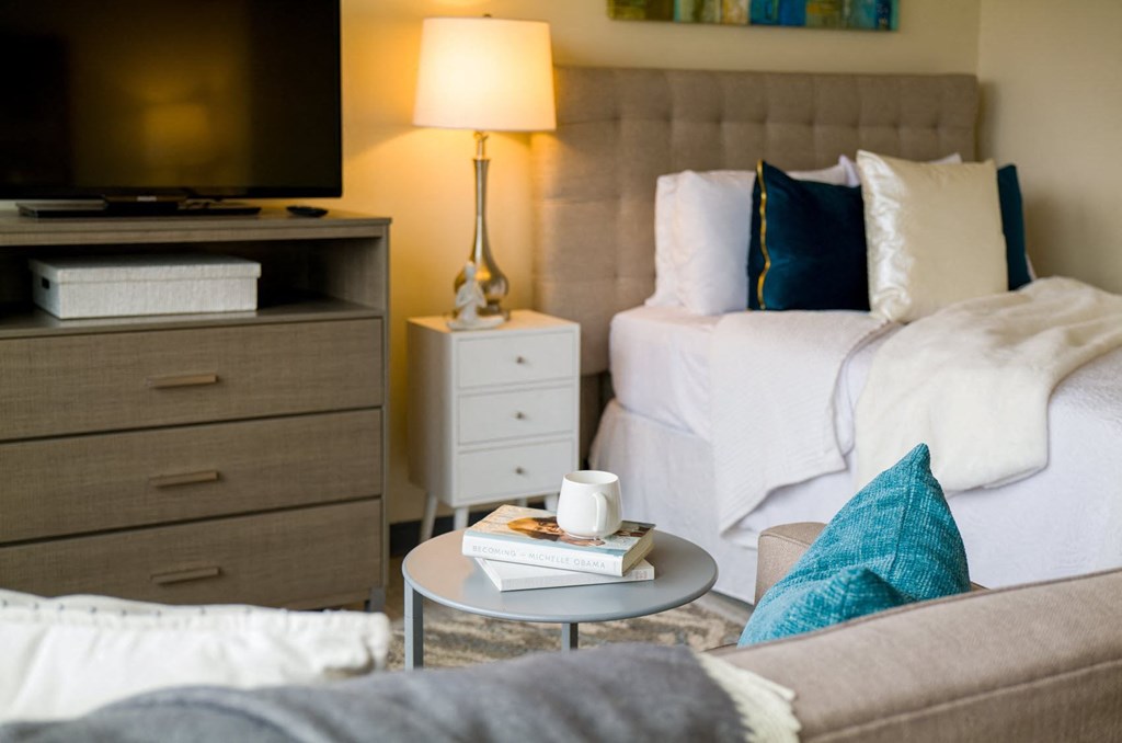 a bedroom with two beds and a couch and a coffee table with a book on