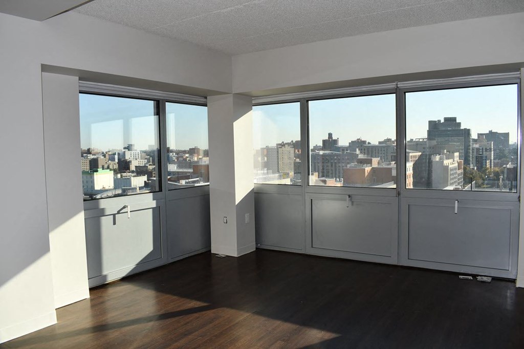 an empty living room with a view of the city