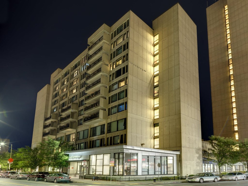 a night view of an apartment building on a city street
