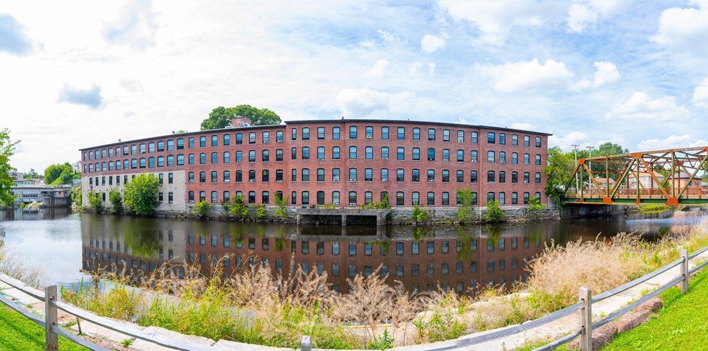 a large brick building sitting next to a body of water