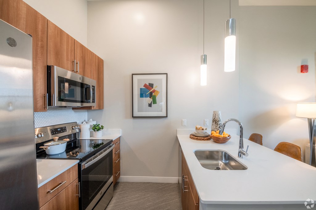 a kitchen with stainless steel appliances and a white counter top