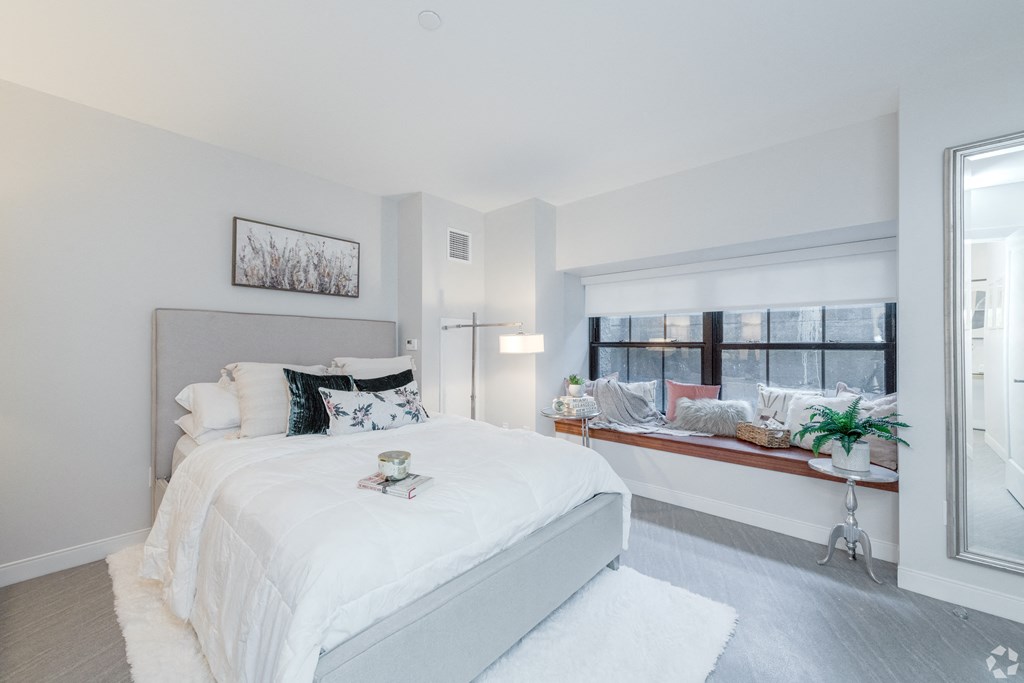 a bedroom with a large bed and a window