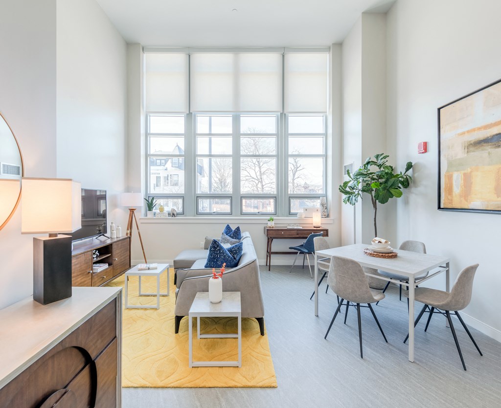 a living room with a table and chairs and a couch