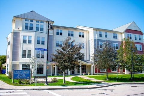 an image of an apartment building on the corner of a street