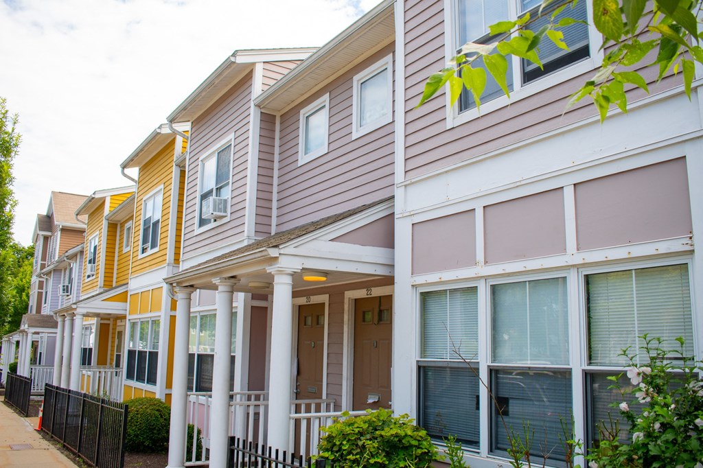 a row of townhomes with gray and yellow siding