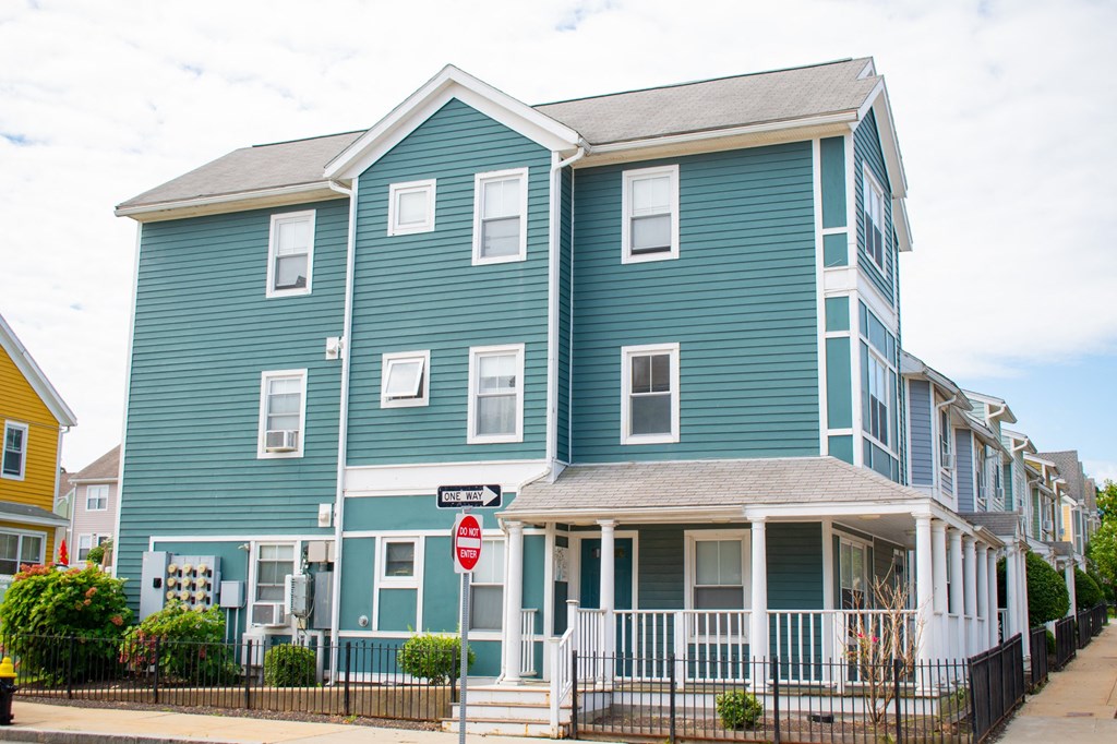 a blue building with a stop sign in front of it