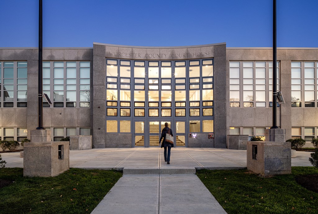 a woman walking in front of a building