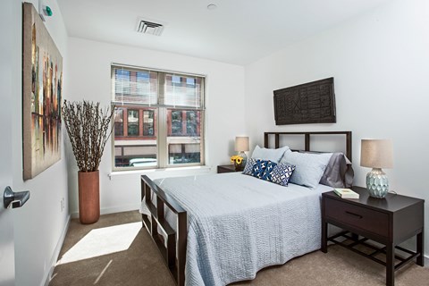 a bedroom with a large bed and a window