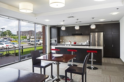 A modern kitchen with a dining table and chairs.