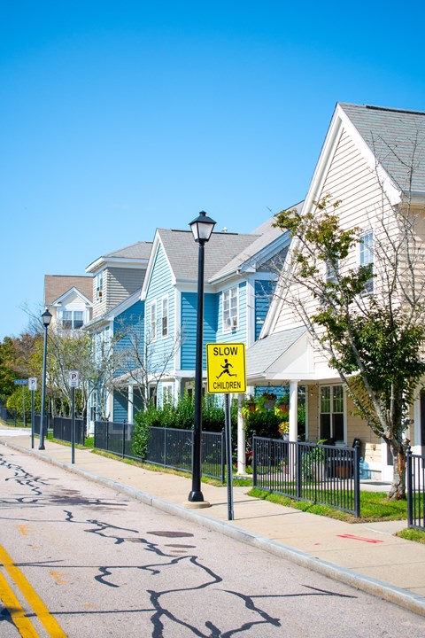 a row of blue and white houses on the side of a street