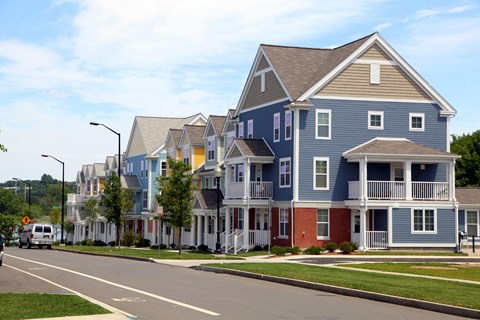 a row of colorful homes on the side of a street