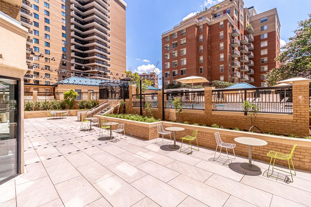 an outdoor patio with tables and chairs