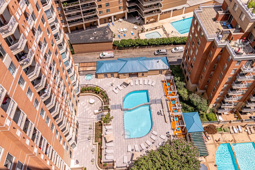 an aerial view of a swimming pool in an apartment building
