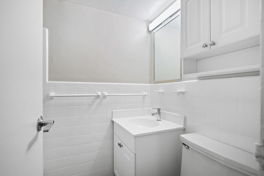 an empty bathroom with a sink and a mirror
