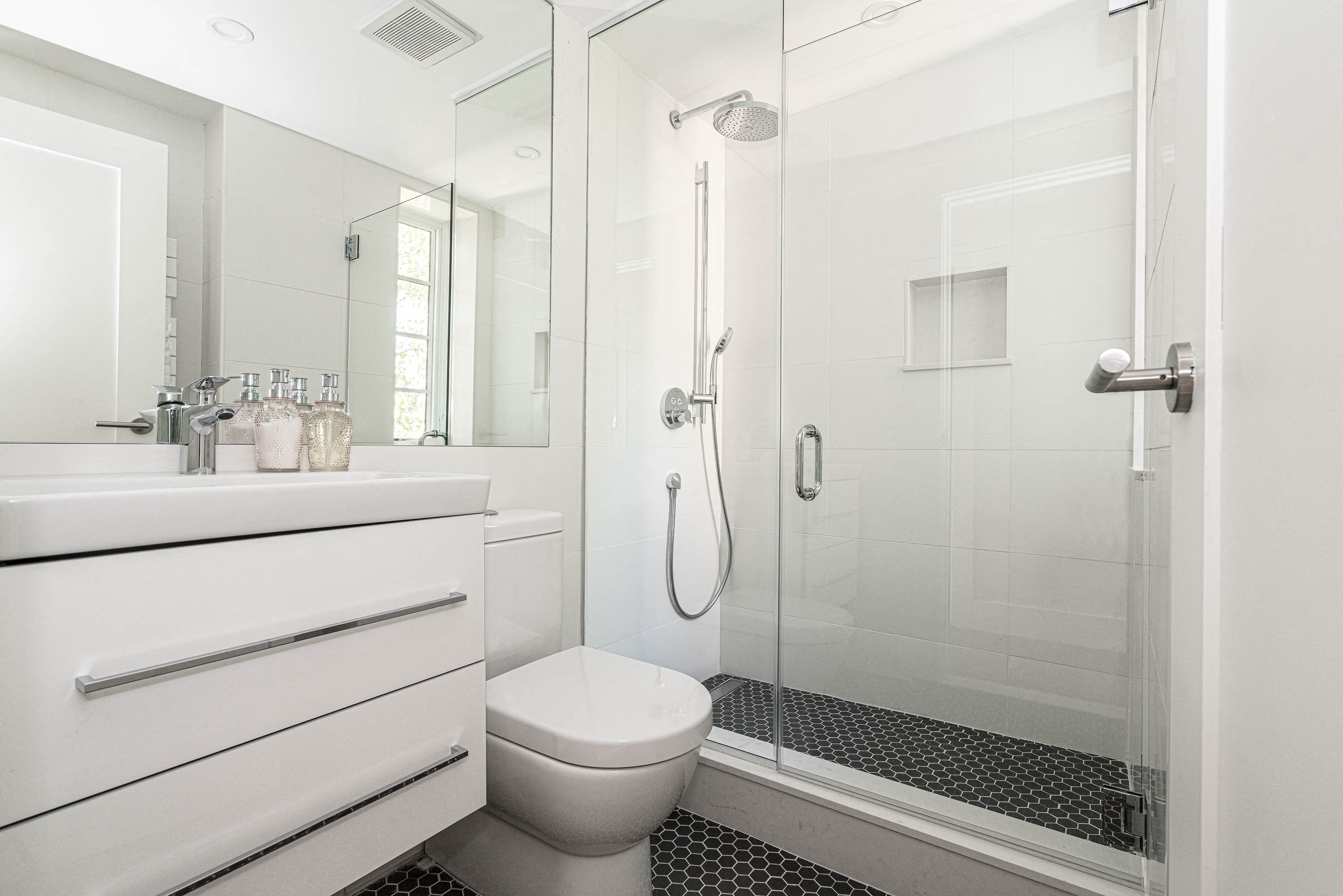 stylish bathroom with chrome fixtures and a rain shower