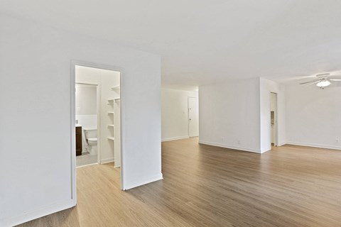 a living room with a hard wood floor and white walls