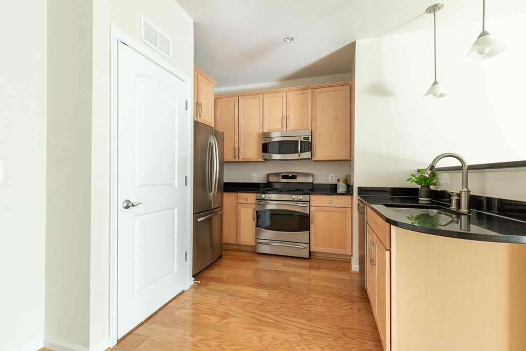 a kitchen with wooden cabinets and stainless steel appliances