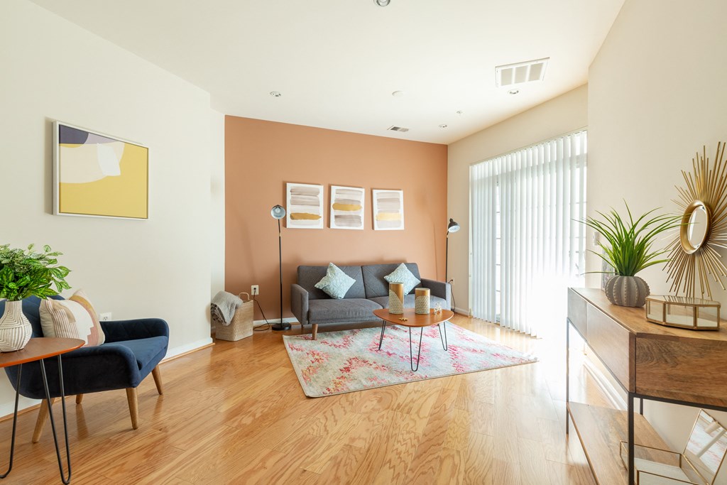 a living room with a couch and a table on a rug