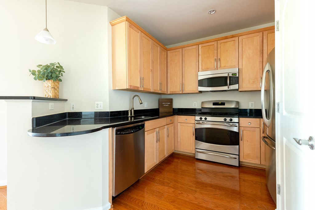 a kitchen with wooden cabinets and stainless steel appliances