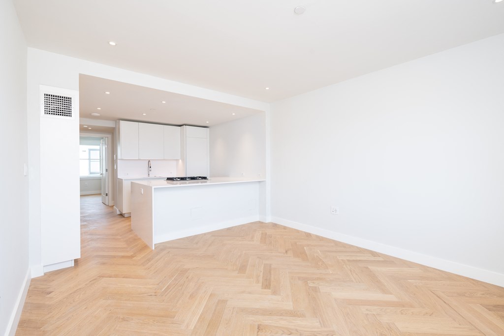a kitchen and dining area in a 555 waverly unit