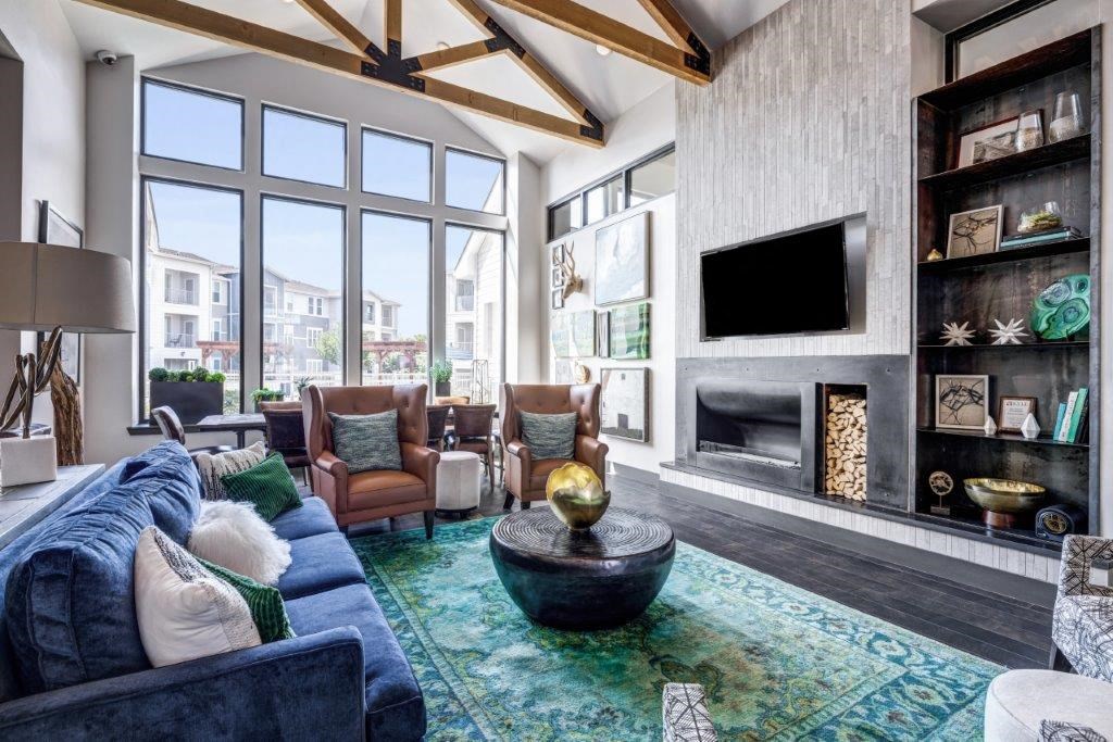 a living room with a blue couch and a fireplace