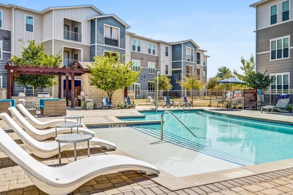 our apartments offer a swimming pool with lounge chairs and tables