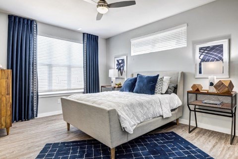 a bedroom with a bed and a ceiling fan