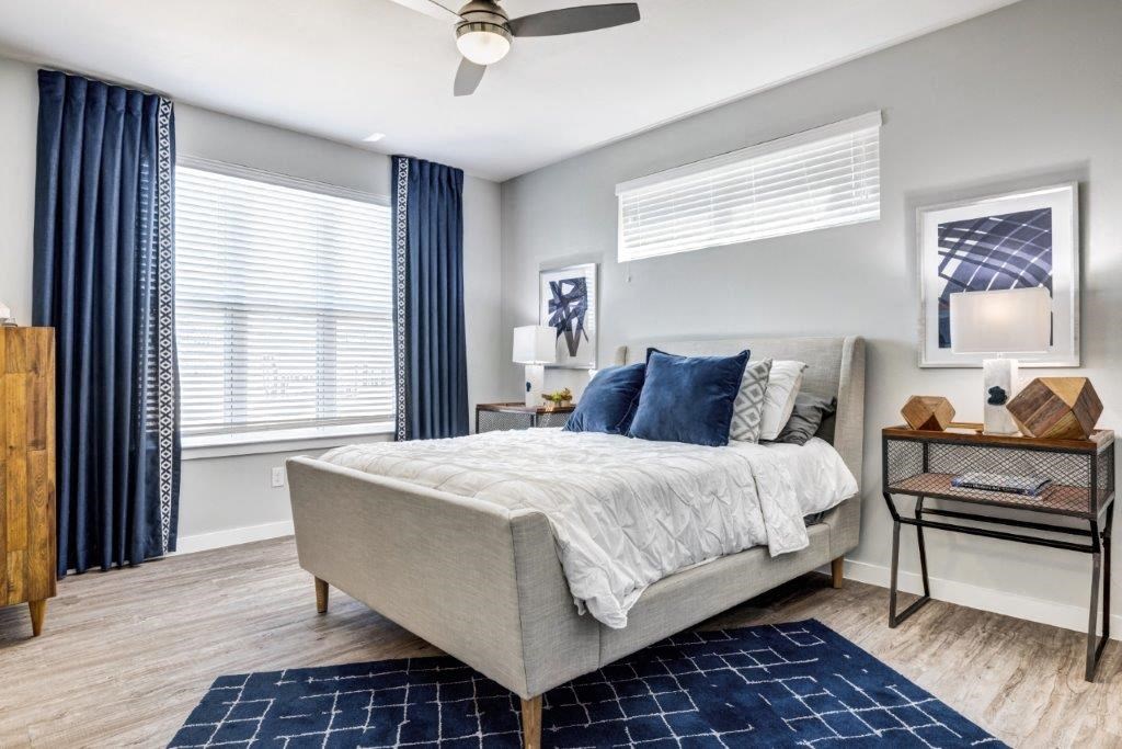 a bedroom with a bed and a ceiling fan