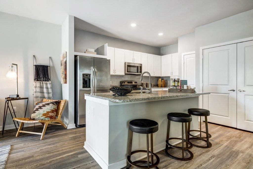 a kitchen with a counter top and a refrigerator