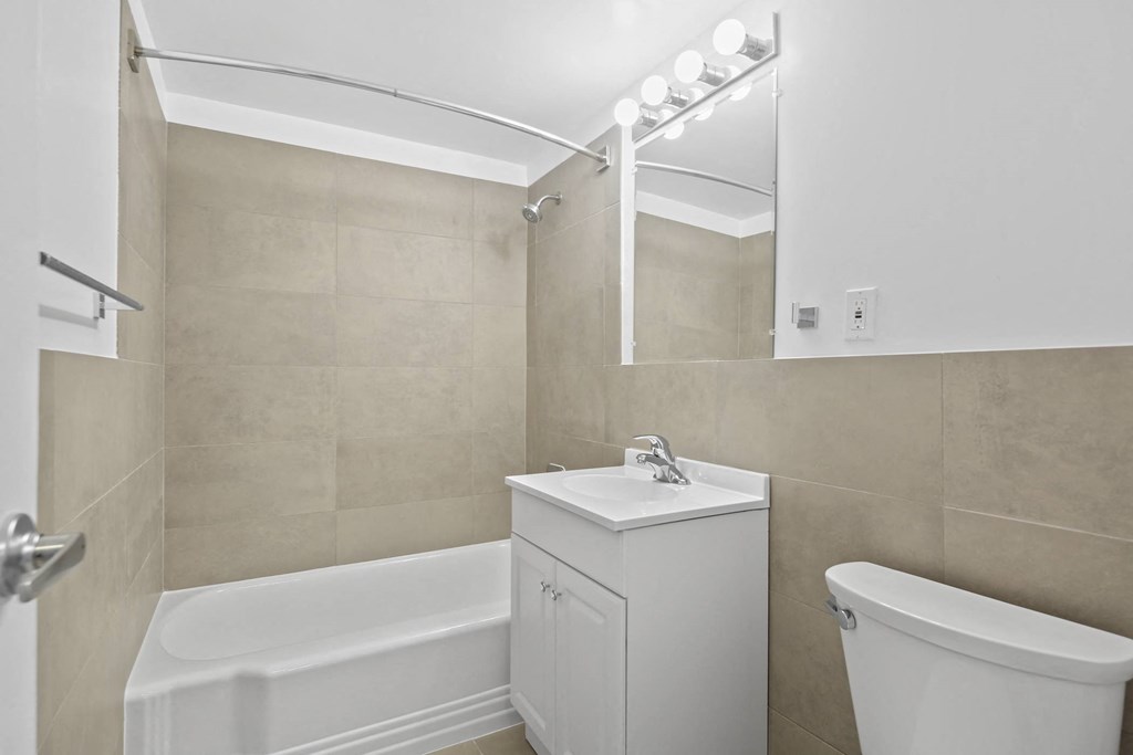 a bathroom with a sink toilet and a bath tub