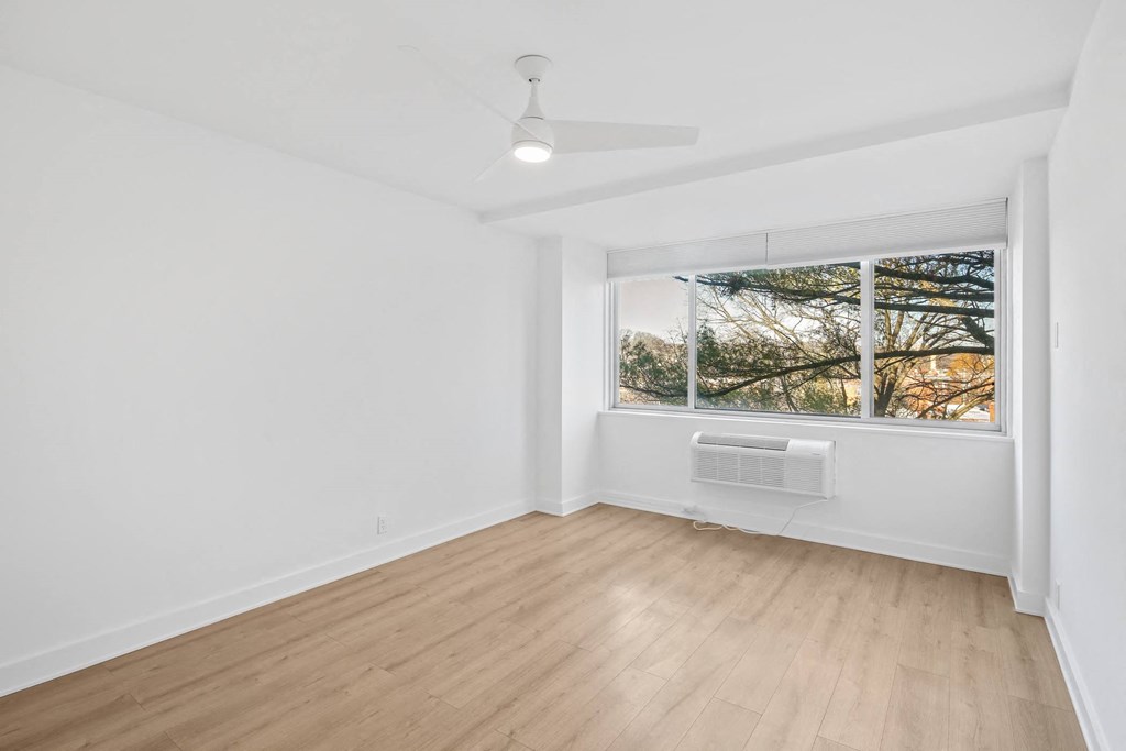 a living room with white walls and a window