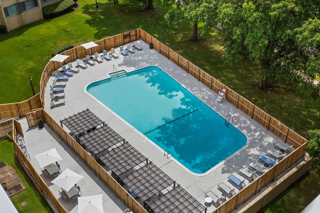 arial view of a swimming pool with chairs around it
